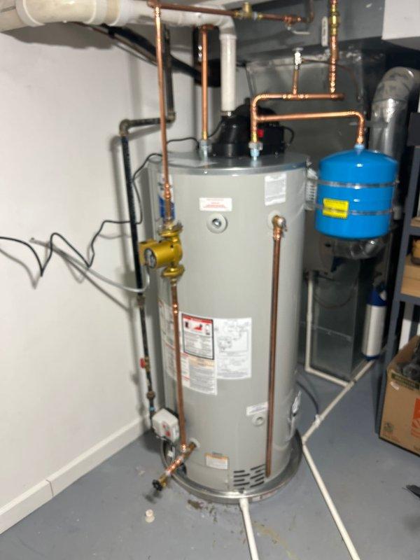 Completed hot water heater installation in utility room with proper copper supply lines and connections. Installed new expansion tank and verified all fittings were secure with no leaks. System was tested for proper operation and is now functioning correctly.
