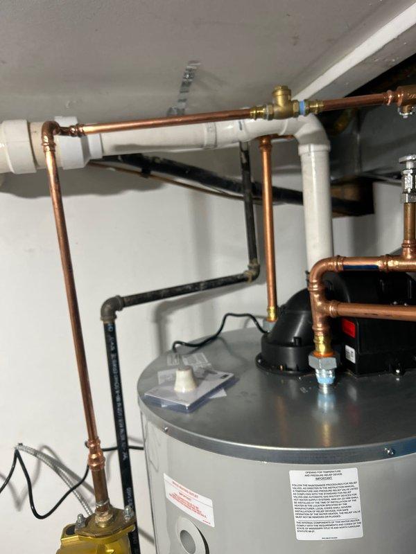 Completed hot water heater installation in utility room with proper copper supply lines and connections. Installed new expansion tank and verified all fittings were secure with no leaks. System was tested for proper operation and is now functioning correctly.