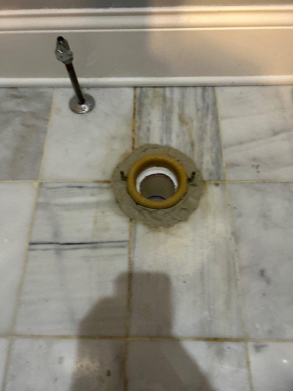 Responded to service call for leaking toilet in master bathroom. Diagnosed issue with deteriorated wax ring seal causing water seepage around floor drain. Removed toilet, replaced wax ring and rubber seal, then reinstalled and tested fixture for proper function and no leakage.