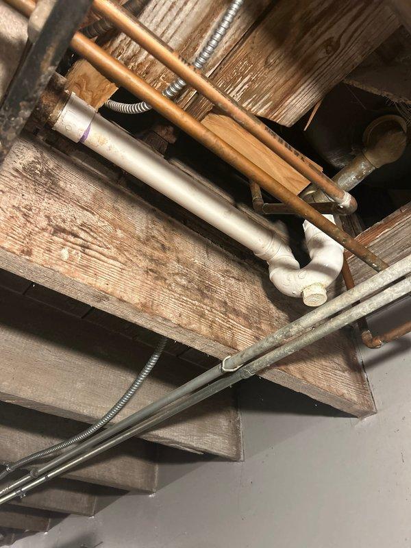 Performed water leak investigation for shower/tub assembly in response to customer report of water intrusion into unfinished basement. Visual inspection revealed water staining on ceramic tile surround and possible gap between tub and wall. Examination of basement ceiling showed copper supply lines and PVC drainage pipes under the bathroom fixture area. Located and identified the source of the leak.