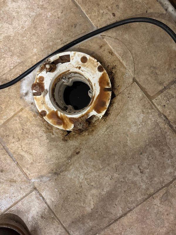 Conducted detailed inspection of commercial drainage system, documenting significant deterioration and rust on floor drain flange with visible water damage to surrounding tile. Evaluated sump pump installation, noting proper PVC discharge pipe configuration and electrical connections, recommending replacement of corroded floor drain assembly to prevent potential water intrusion issues.