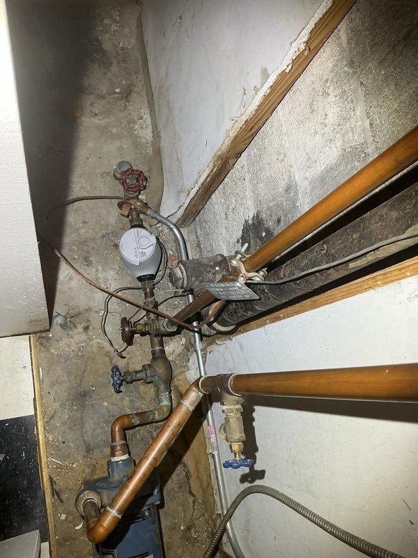 Conducted comprehensive assessment and replacement of lead supply piping in utility area, along with installation of new backflow prevention device. Removed aging copper pipes showing significant oxidation and replaced deteriorating valve components. System now features updated pressure regulation and compliant backflow protection to ensure water safety standards are met.