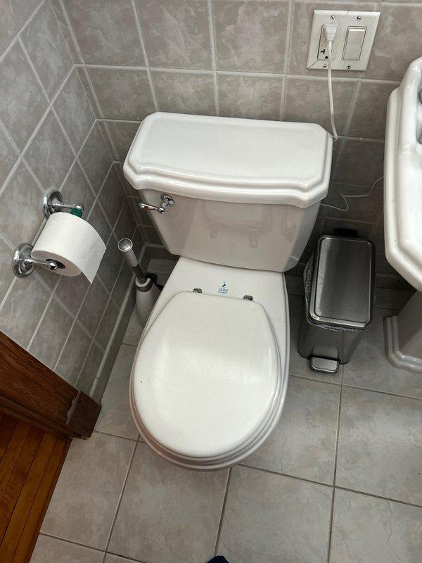 Responded to customer complaint of suspected toilet leak affecting neighboring unit in 80-year-old home. Upon inspection, removed toilet to examine wax ring, which showed deterioration and water damage around the flange area with visible staining. Replaced damaged wax ring, cleaned flange mounting area, and reinstalled toilet with new sealing components to prevent further leakage.