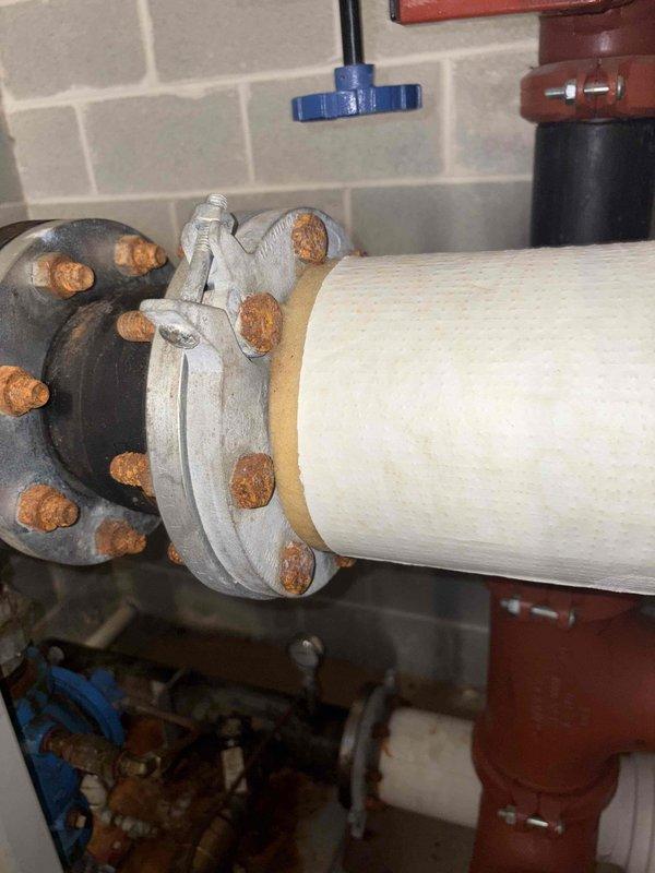 Installed booster pump system with pressure gauge monitoring capabilities. Identified significant corrosion on flange bolts connecting to main supply line, with gauge currently reading approximately 3.5-4 bar. System requires follow-up service to address rust deterioration at connection points.