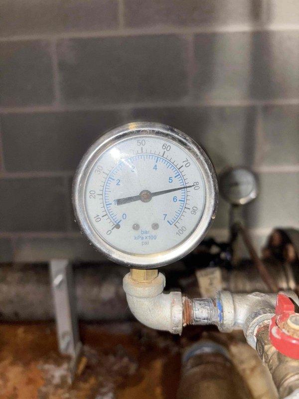 Installed booster pump system with pressure gauge monitoring capabilities. Identified significant corrosion on flange bolts connecting to main supply line, with gauge currently reading approximately 3.5-4 bar. System requires follow-up service to address rust deterioration at connection points.
