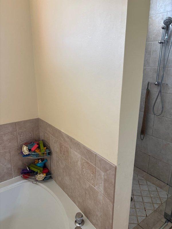 Responded to service call regarding water leak from second floor bathroom into first floor bathroom. Upon inspection, located the source of the leak at a PVC pipe connection with purple primer markings in the ceiling cavity. Created access point through ceiling drywall to facilitate repair and prevent further water damage to the surrounding structure.
