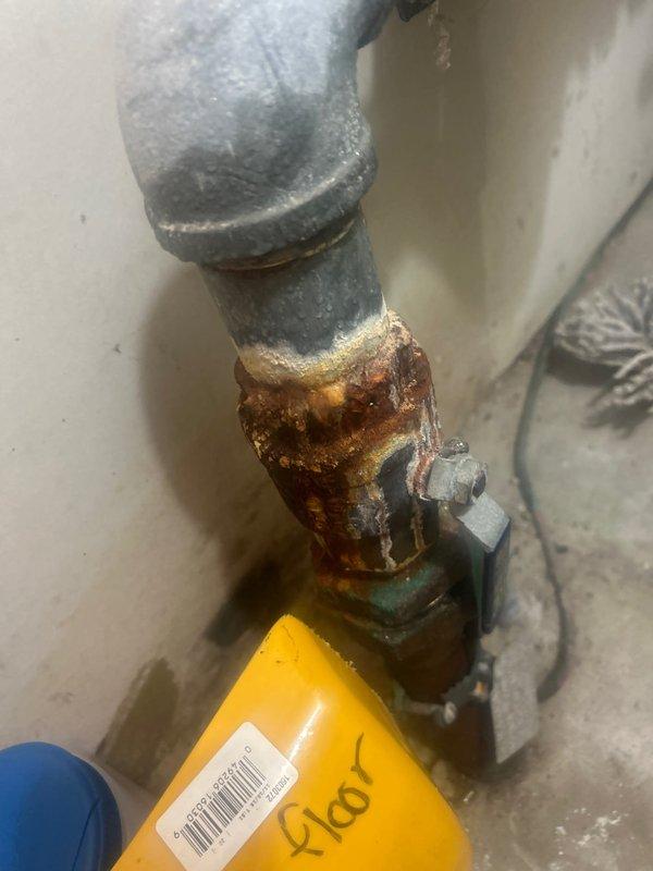 Inspected morning ejector pump system and identified severe corrosion and rust damage at pipe connection joints. Observed compromised galvanized steel piping with significant deterioration at valve assembly. Installed ProFlex water hammer arrestor on copper supply lines to resolve pressure fluctuation issues and prevent future system damage.