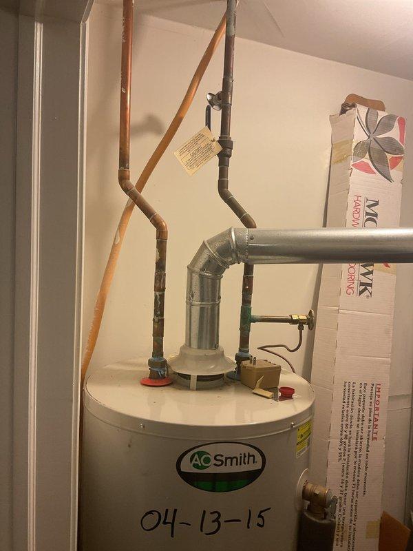 Diagnosed 8-year-old A.O. Smith 50-gallon water heater with pilot light failure. Unit installed in 2015 was non-functional with customer reporting complete loss of hot water. Visual inspection of unit in utility closet confirmed proper installation with standard copper supply lines, insulated piping, and ventilation system intact.