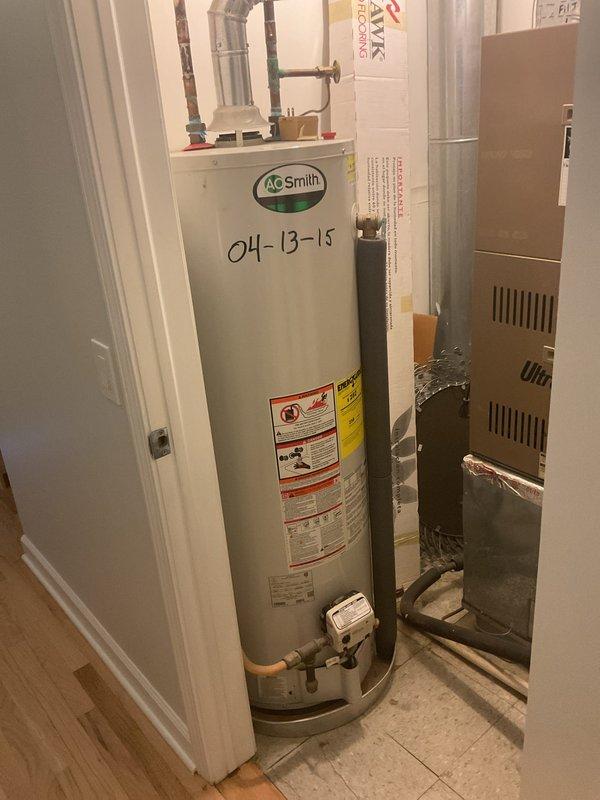 Diagnosed 8-year-old A.O. Smith 50-gallon water heater with pilot light failure. Unit installed in 2015 was non-functional with customer reporting complete loss of hot water. Visual inspection of unit in utility closet confirmed proper installation with standard copper supply lines, insulated piping, and ventilation system intact.