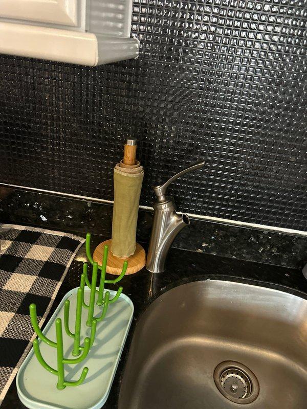 Diagnosed and repaired kitchen faucet leaking from underneath by replacing worn O-rings and tightening loose supply line connections. Tested water flow and drainage after repair, confirming complete resolution of the leak that had been ongoing for over a week.