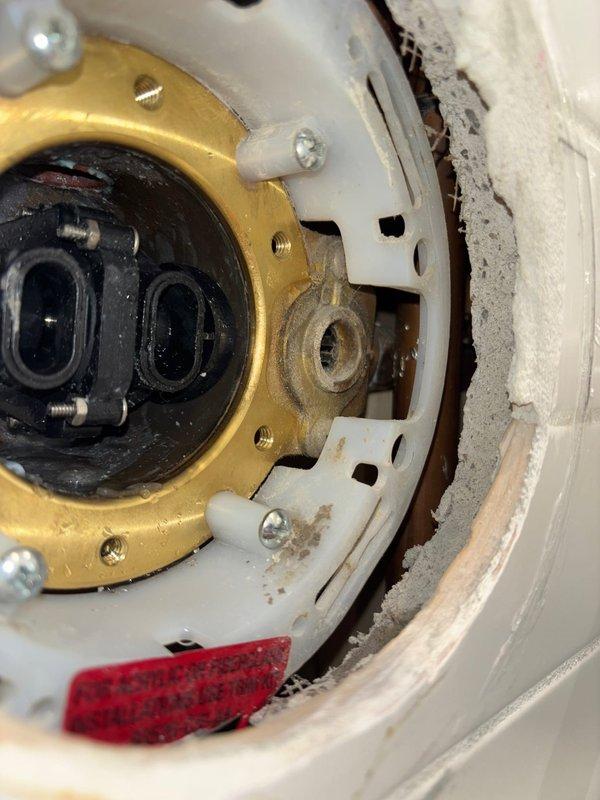 Completed disassembly and inspection of valve assembly per work order. Documented condition of brass fitting with mounting holes and internal components. Verified proper installation of mechanical components in acrylic/fiberglass housing, noting some normal wear on the white housing components.