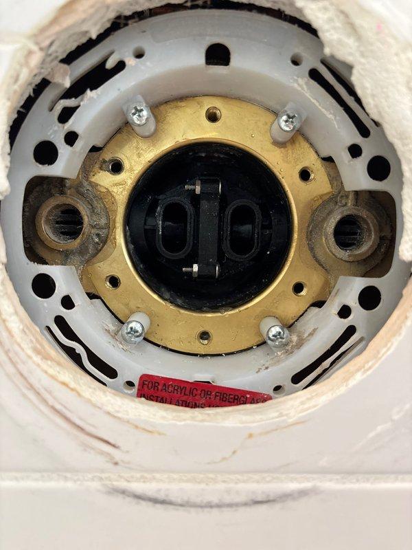 Completed disassembly and inspection of valve assembly per work order. Documented condition of brass fitting with mounting holes and internal components. Verified proper installation of mechanical components in acrylic/fiberglass housing, noting some normal wear on the white housing components.