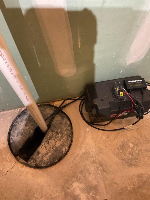 Installed replacement Liberty Pumps backup system on existing sump pump installation. Verified proper operation of system with water present in sump pit. Confirmed PVC discharge pipe connections were secure with no leaks detected.