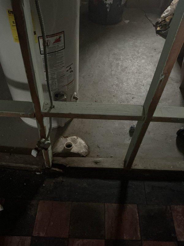 Conducted an assessment for check valve installation on residential sewer line. Inspected the utility room housing the water heater and examined the concrete drainage structure which showed signs of weathering and sediment accumulation. Determined appropriate location and specifications for backwater valve installation to prevent sewer backflow.