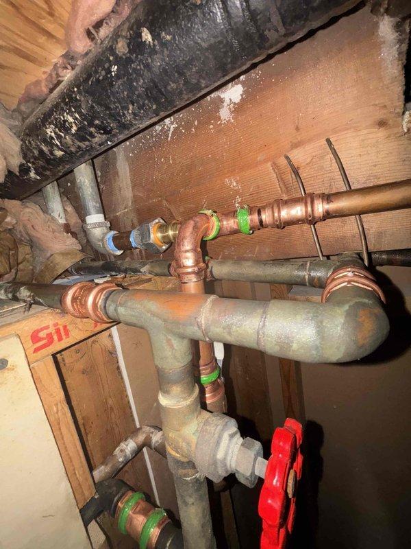 Successfully completed the replacement of approximately one foot of deteriorated galvanized piping, installing new brass nipples to adapt back to the existing 3/4" copper lines. Work required demolition of bedroom ceiling to access the affected plumbing infrastructure, with all connections properly secured and tested to ensure system integrity.