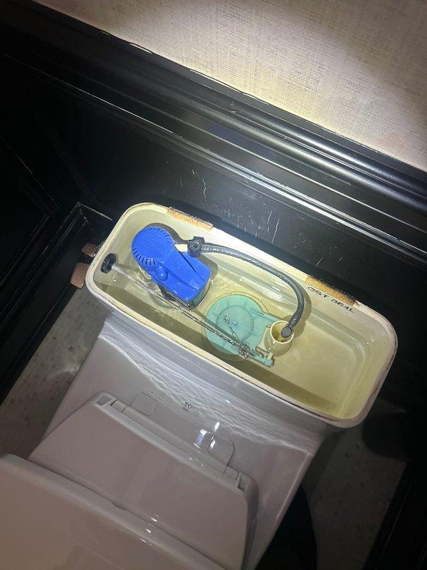 Inspected multiple plumbing issues including a kitchen pipe with a hole before the trap, a dripping pipe from basement tub, third floor tub spout diverter malfunction, toilet with abnormal refill noise, and shower handle stability problem. Documented conditions with photos of bathroom sink installation and toilet tank internal components showing aged float mechanism and potential mineral buildup requiring replacement.