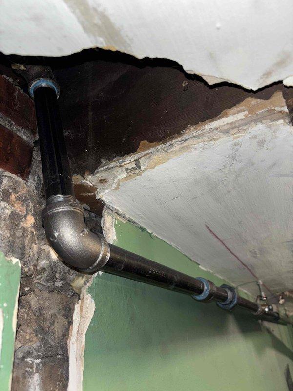 Responded to a VIP service call regarding a suspected gas leak in a 120-year-old residence. Conducted comprehensive pressure testing on the gas system, with particular focus on the Weil-McLain boiler unit showing significant rust along the base. Inspected associated PVC piping infrastructure, including deteriorated connections near the ceiling-wall junction, and successfully identified and addressed the source of the gas leak to restore safe operation of the system.