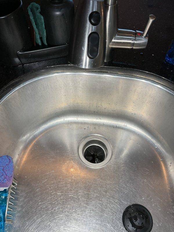 Responded to service call for kitchen sink clog that had previously been unclogged months prior. Upon inspection of the stainless steel sink and under-sink plumbing, determined deeper blockage issue in the drain line. Successfully cleared the obstruction to restore proper drainage functionality.