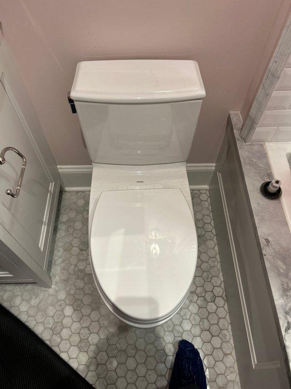 Successfully removed and hauled away old toilet, replacing it with a new unit including installation of new wax seal, bolts, and shut-off valve. Work included proper disposal of old fixture and ensuring the new toilet was correctly mounted to the existing hexagonal tile floor with appropriate sealing at the flange connection.
