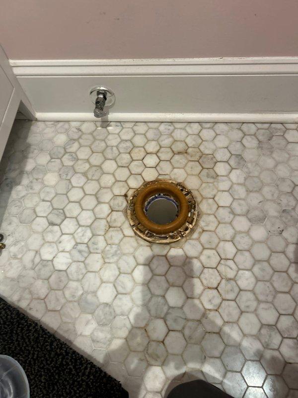 Successfully removed and hauled away old toilet, replacing it with a new unit including installation of new wax seal, bolts, and shut-off valve. Work included proper disposal of old fixture and ensuring the new toilet was correctly mounted to the existing hexagonal tile floor with appropriate sealing at the flange connection.