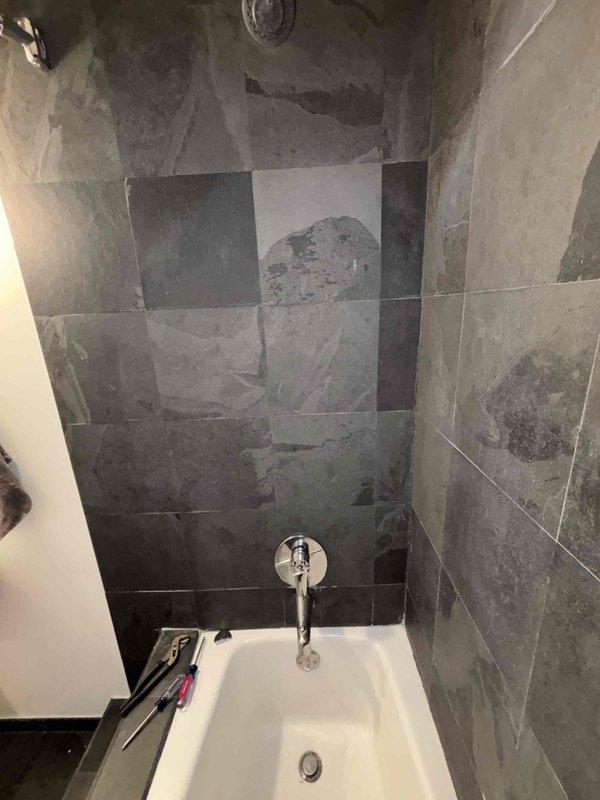 Installed customer-supplied cartridge in one bathtub valve and replaced a complete valve with trim kit in second bathtub. Both installations were successfully completed in separate bathrooms, with proper sealing and function testing performed to ensure no leaks and optimal water flow.