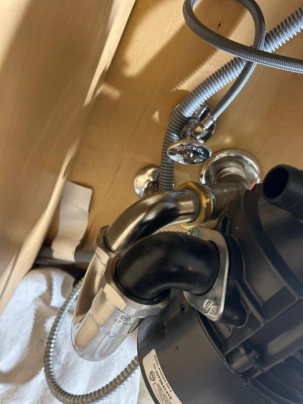 Successfully installed customer-supplied garbage disposal unit beneath the sink, connecting it properly to existing drain system with new P-trap assembly and ensuring all supply lines were securely fastened. Completed installation with verification of proper drainage and operation, leaving the workspace clean with no leaks observed.