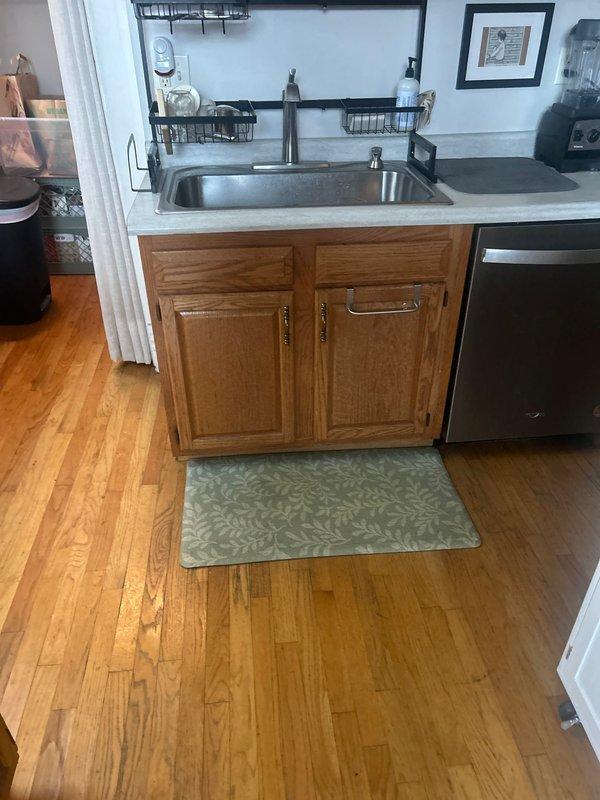 Responded to a callback request to provide an estimate for plumbing work in kitchen area. Inspected under-sink plumbing components and utility space containing PVC and brass piping systems. Documented current installation with photos for reference in preparing comprehensive service proposal.