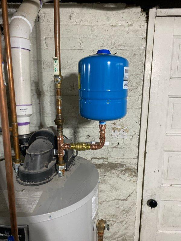 Responded to service call for leaking tanked water heater (2-3 years old). Inspection revealed minor drip from tank connection. Tightened fittings and verified proper operation of expansion tank and supply lines. Leak resolved and system now functioning normally.