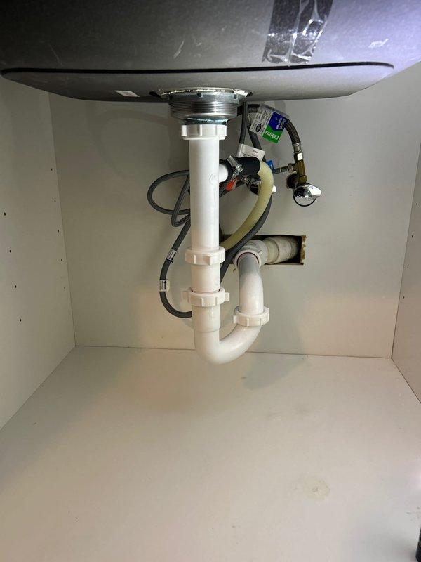 Performed diagnostic assessment on two clogged sinks (kitchen and bathroom) in vintage home. Cleared both drain obstructions using professional-grade equipment and verified proper drainage function. Inspected P-trap assemblies and drain lines for additional issues; installed leak catch container under bathroom sink as preventative measure.