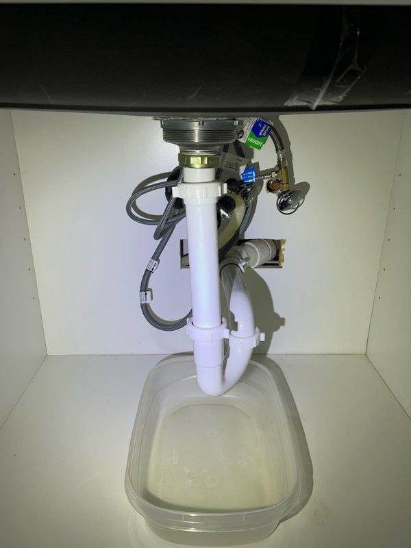 Performed diagnostic assessment on two clogged sinks (kitchen and bathroom) in vintage home. Cleared both drain obstructions using professional-grade equipment and verified proper drainage function. Inspected P-trap assemblies and drain lines for additional issues; installed leak catch container under bathroom sink as preventative measure.