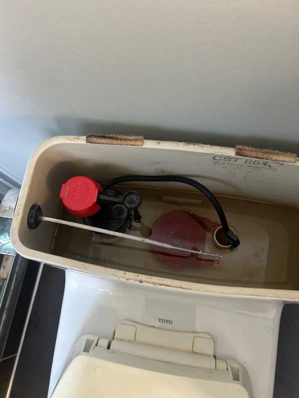 Completed building water shut-down service as scheduled. Inspected toilet tank components showing mineral buildup and aging parts, and verified proper function of bathroom fixture shut-off valve. All water supply lines and valves confirmed operational for future service.