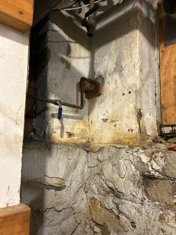 Repaired outdoor spigot that had frozen over winter, causing water to leak into the house. Identified significant water damage to basement wall with visible staining and deterioration around the pipe mounting area. Replaced damaged components and installed new shutoff valve to prevent future leakage issues.