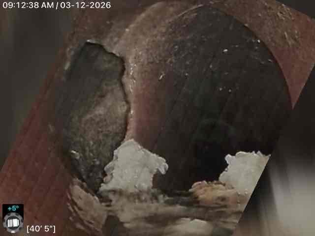 Performed callback inspection of corroded plumbing system using camera equipment. Documented significant interior pipe deterioration with advanced rust formation and possible mineral deposits. Identified potential infiltration issues with fiber-like structures visible along pipe walls, requiring further remediation.