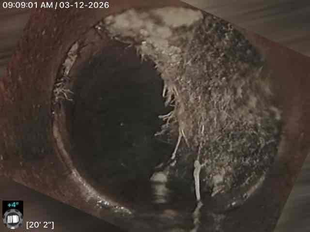 Performed callback inspection of corroded plumbing system using camera equipment. Documented significant interior pipe deterioration with advanced rust formation and possible mineral deposits. Identified potential infiltration issues with fiber-like structures visible along pipe walls, requiring further remediation.