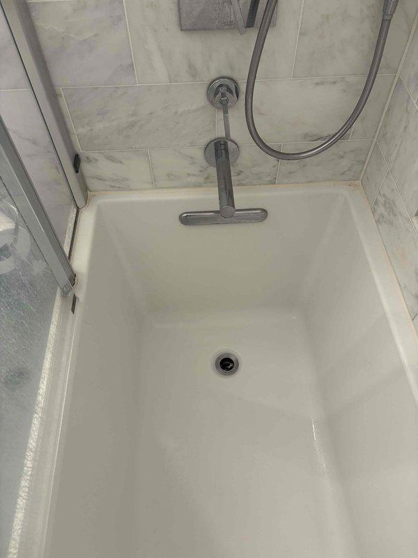 Responded to service call for continuously running Toto toilet and two clogged shower drains. Replaced faulty flush valve seal in toilet tank to resolve refilling issue, then successfully cleared both shower drain blockages using professional drain cleaning equipment, restoring proper drainage function to all affected fixtures.