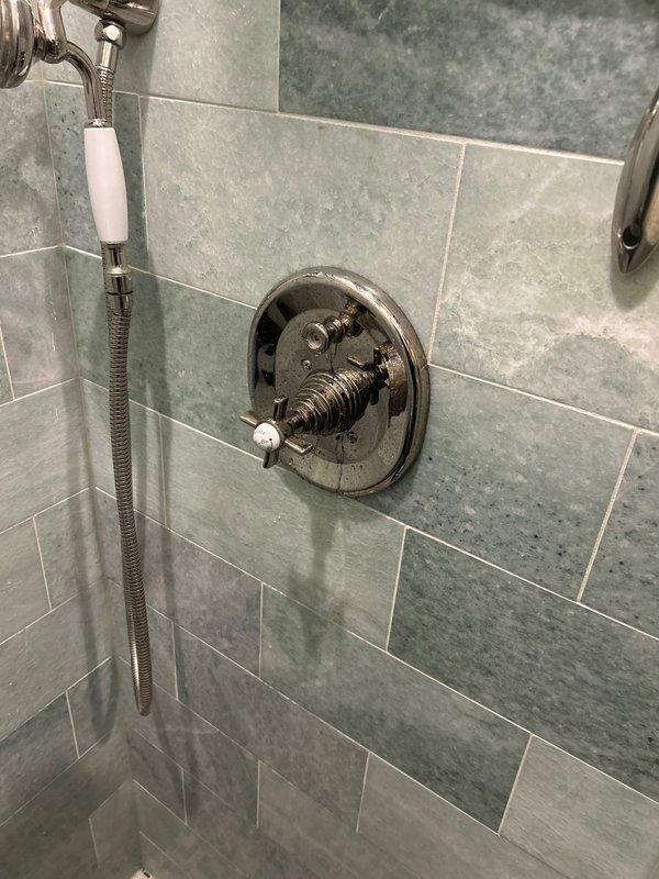 Conducted plumbing inspection of multiple fixtures including a kitchen faucet with low water pressure, a leaking shower fixture, and two bathtubs requiring drain stopper installations. Examined the professional-style kitchen faucet with pull-down sprayer and identified potential clogging causing reduced water pressure. Also inspected shower installation with chrome control valve and handheld showerhead to address reported leak.