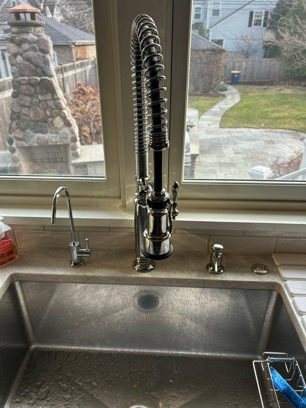 Conducted plumbing inspection of multiple fixtures including a kitchen faucet with low water pressure, a leaking shower fixture, and two bathtubs requiring drain stopper installations. Examined the professional-style kitchen faucet with pull-down sprayer and identified potential clogging causing reduced water pressure. Also inspected shower installation with chrome control valve and handheld showerhead to address reported leak.
