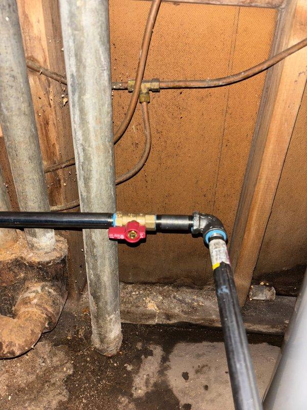 Performed complete water heater installation in basement utility area. Installed new unit with proper venting using galvanized metal pipe, connected copper supply lines, and installed shut-off valve on PVC drainage. Noted and documented significant water damage and corrosion on ceiling joists above previous unit.