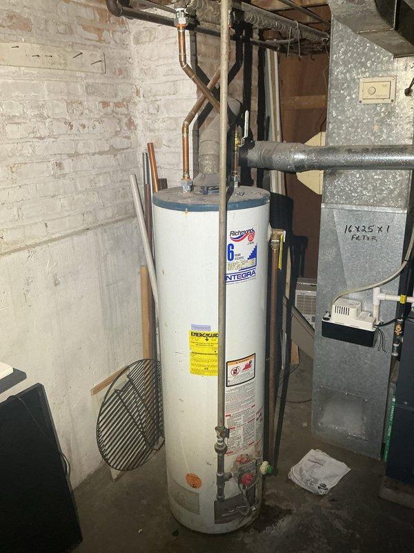Conducted comprehensive inspection of basement utility area, focusing on water heater system with connected copper plumbing. Performed camera inspection of circular duct/pipe system, revealing significant buildup of dirt, dust and possible mold extending 42 feet with internal temperature reading of +12°. Documentation completed with timestamp photos showing condition of mechanical systems and extent of contamination requiring remediation.