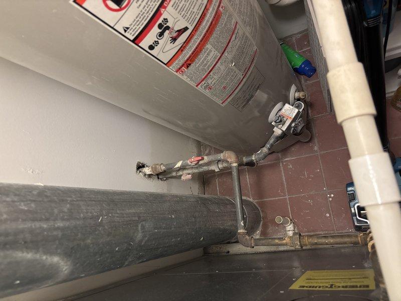 Conducted inspection of a 15+ year old 50-gallon water heater displaying significant corrosion on connecting pipes and requiring replacement. Noted building requires advance notification for water shutdown due to absence of in-unit shutoff valves. Additionally assessed kitchen sink with leaking faucet that may need replacement.