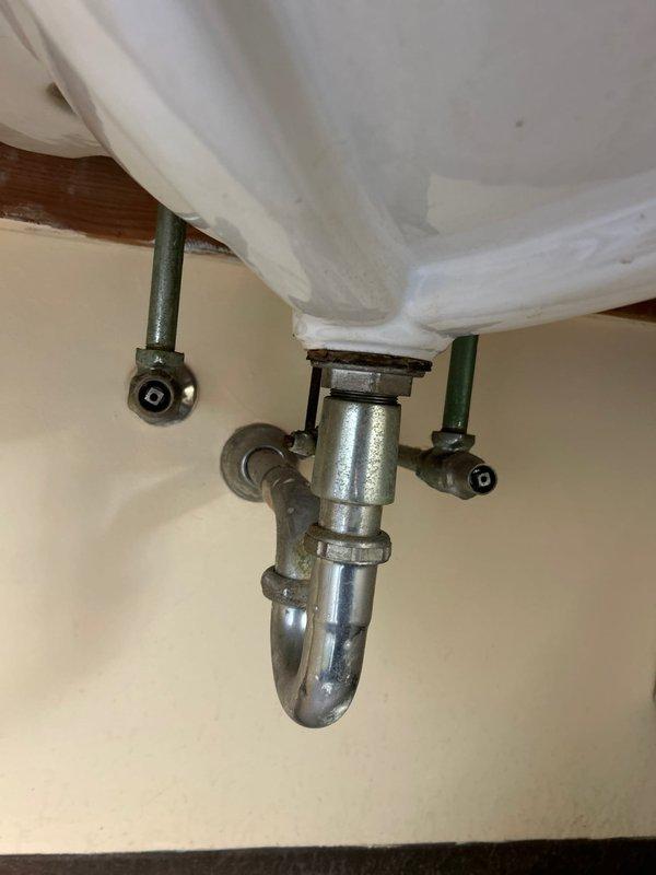 Repaired commercial toilet with malfunctioning Sloan flush valve that was continuously cycling. Inspected sink plumbing and replaced worn hot water cartridges in multiple lavatory faucets to restore proper hot water function. All fixtures tested and confirmed working correctly upon completion.