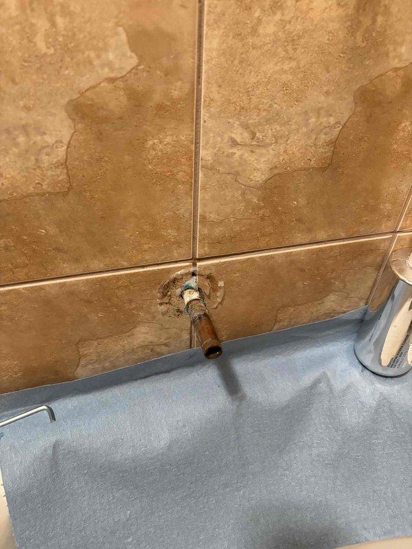 Reinstalled tub spout that was previously replaced but had become displaced approximately one inch from the wall surface. Secured fixture properly to ensure correct alignment and prevent water intrusion behind the tile surface.