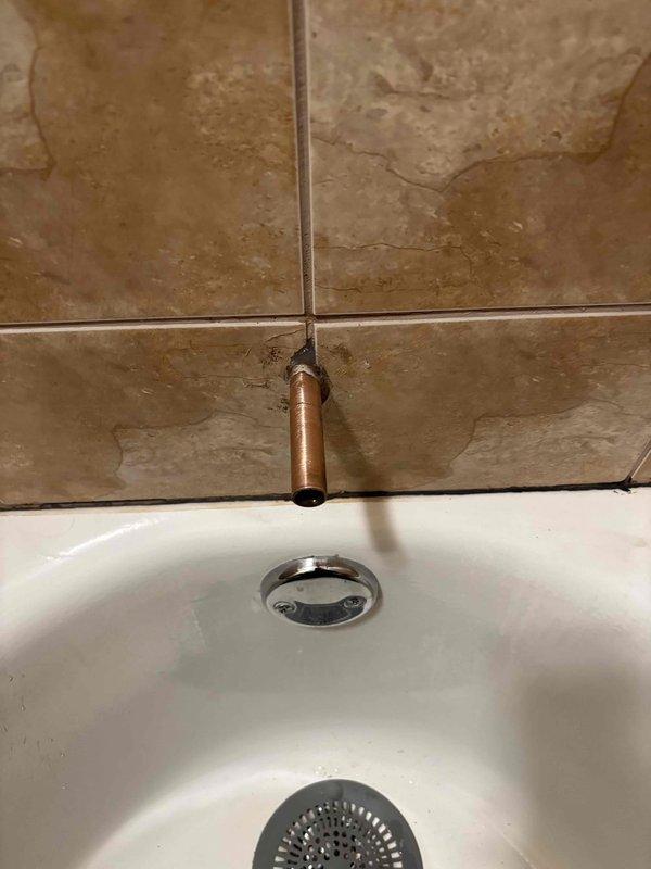 Reinstalled tub spout that was previously replaced but had become displaced approximately one inch from the wall surface. Secured fixture properly to ensure correct alignment and prevent water intrusion behind the tile surface.