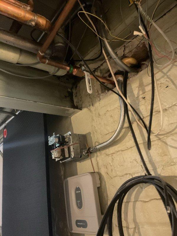 Investigated outdoor hose bib leak reported by customer. Inspected the plumbing system in the unfinished basement, identifying copper supply lines and existing valve assembly. Repaired the leaking outdoor spigot by replacing the worn washer and packing nut, restoring proper function and eliminating the leak.