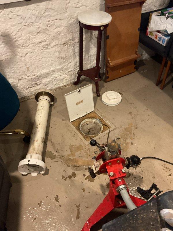 Responded to main line backup with cleanout access in basement showing signs of overflow. Utilized power auger equipment to clear significant blockage in the main drain line. Visual inspection with camera revealed extensive corrosion and oxidation at pipe junction approximately 7'7" into the line, which was likely contributing to recurring backup issues.