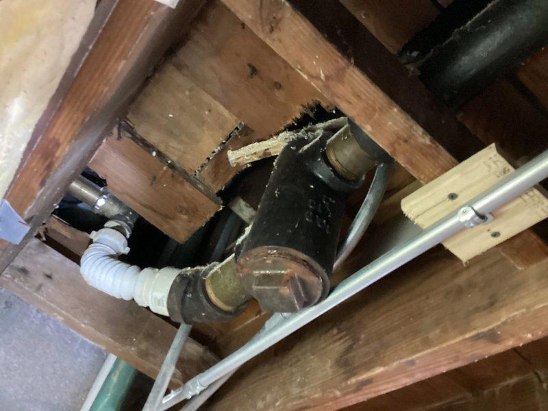 Investigated sewer odor in basement that occurs during rainfall. Inspection revealed corroded cast iron drain pipe with Y-junction showing significant aging and deterioration at connection points, likely causing sewer gas to escape. Recommended replacement of deteriorated sections and proper sealing of all pipe connections to prevent future gas leakage during weather events.