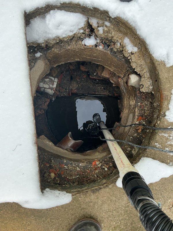 Conducted inspection of damaged catch basin in backyard using specialized camera equipment. Documented significant structural deterioration, including broken brickwork, damaged terracotta piping, and standing water accumulation. Provided estimate for complete catch basin rebuilding as requested.