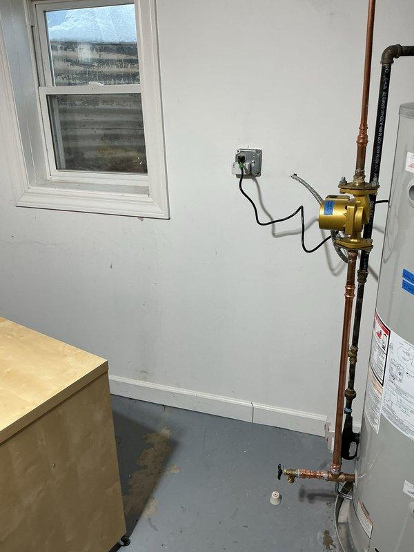 Responded to water intrusion complaint in basement following recent sump pump installation. Inspection revealed water staining near plumbing system base in utility room. Installed PVC discharge pipe with control valve to properly direct water flow away from foundation, resolving the basement flooding issue.
