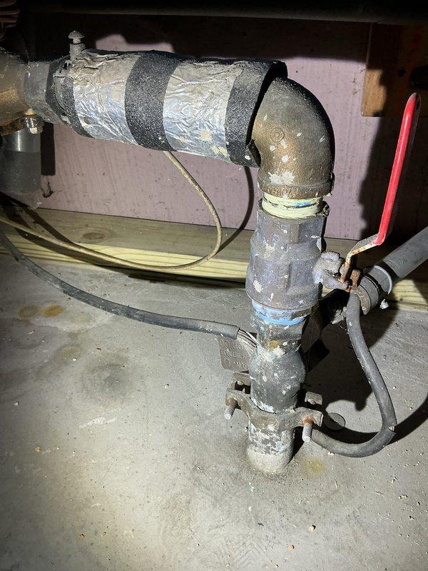Conducted a comprehensive assessment for water main replacement in a residential utility area. Inspected aging plumbing system including vertical metal pipes with multiple connections, insulated horizontal pipe sections, and control valves. Documented existing conditions including signs of wear on components and took detailed photos for estimate preparation.
