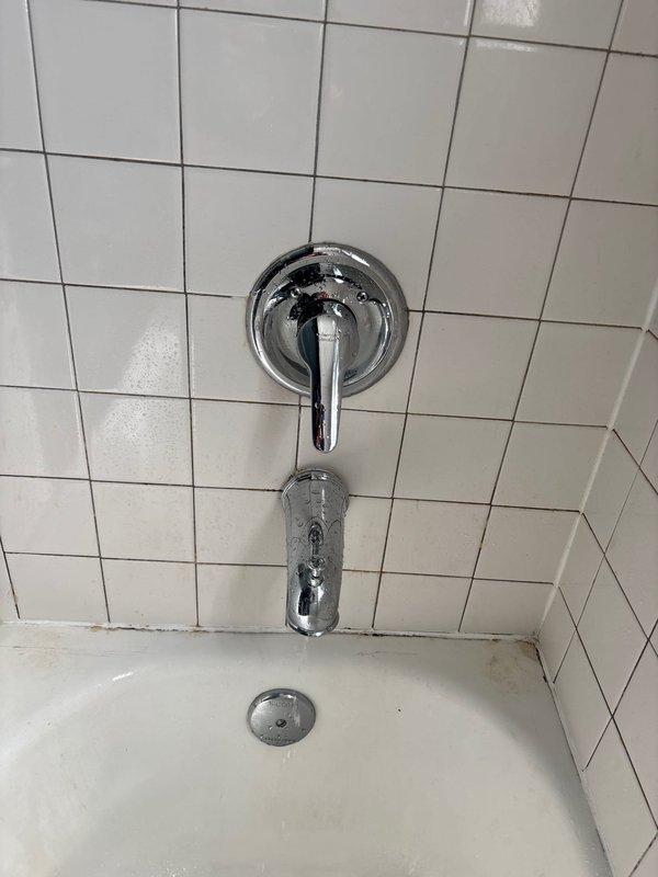 Diagnosed and repaired second floor shower exhibiting low/no water pressure and continuous water leakage from faucet when turned off. Disassembled valve assembly, removed calcium deposits and mineral buildup affecting pressure and causing diverter malfunction, then reassembled and tested to confirm proper water flow and complete shutoff.